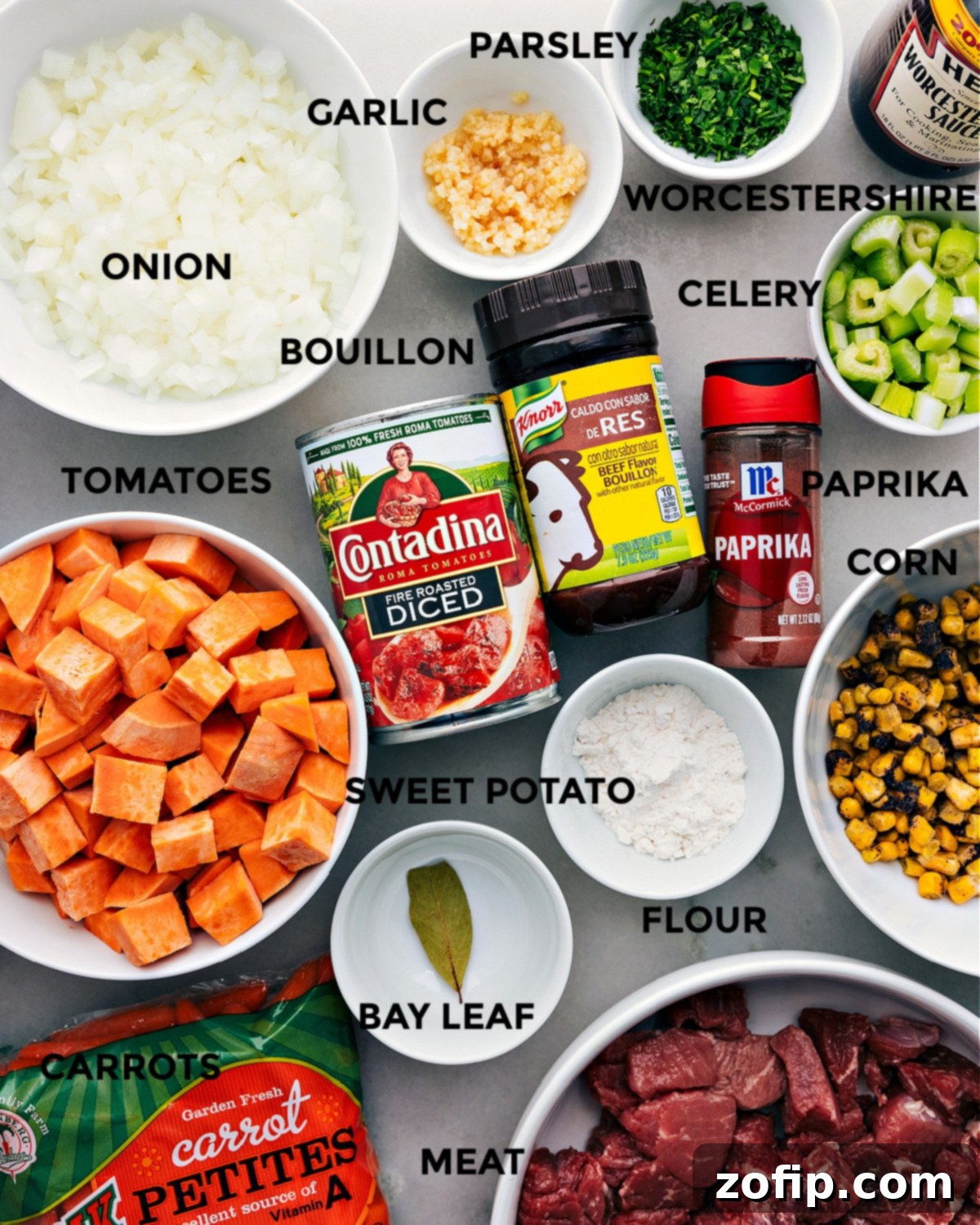A vibrant selection of fresh ingredients, including sweet potatoes, carrots, celery, and beef, prepped and ready for the Slow Cooker Sweet Potato Stew.