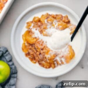 Close-up of a freshly baked Apple Dump Cake in a ceramic dish, golden brown and bubbly.