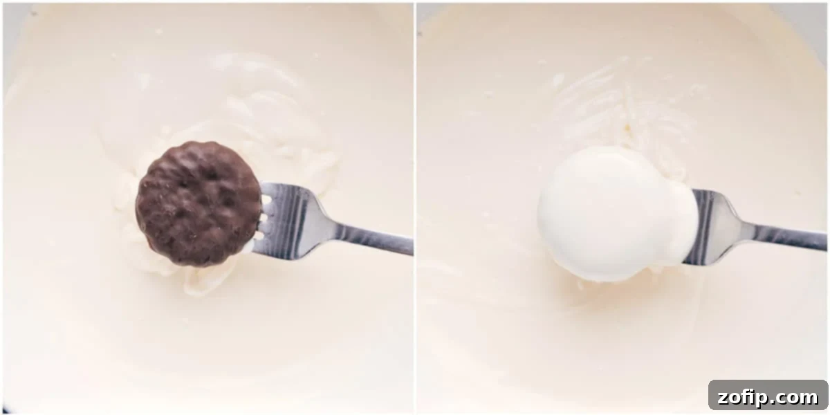 Dipping the mint cookies in melted white chocolate, a crucial step for these easy peppermint cookies.