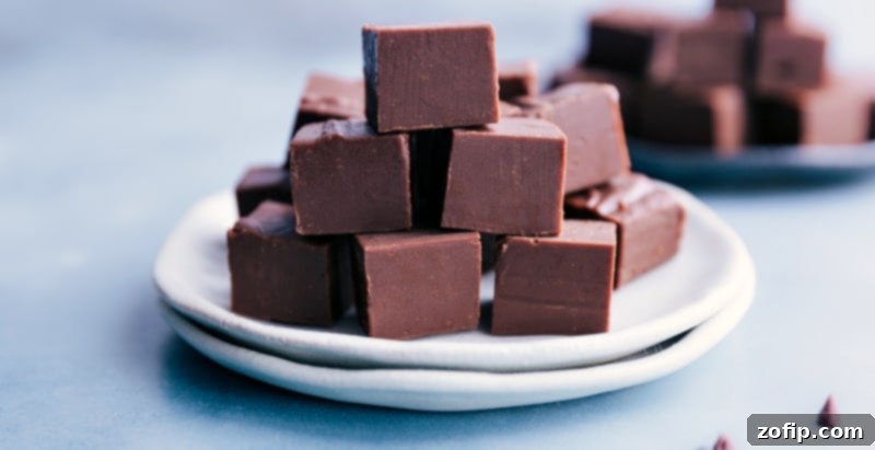 Homemade chocolate Fudge Recipe! No special equipment or candy thermometer needed to make this quick and delicious candy. Recipe via ChelseasMessyApron.com #fudge #candy #chocolate #easy #fast #treat Fudge cut into squares and stacked on a plate