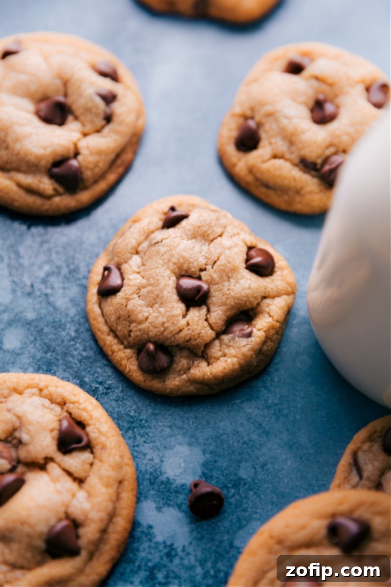 Stacked arrangement of perfectly baked Peanut Butter Chocolate Chip Cookies, showcasing their golden-brown color, melty chocolate chips, and thick, soft centers.