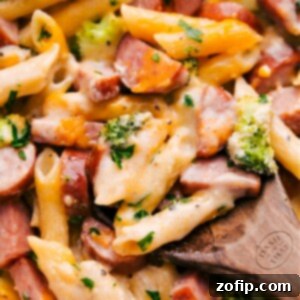 Close-up of Cheesy Sausage Pasta in a baking dish, garnished.