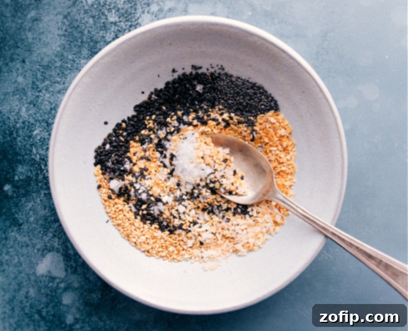 Close-up shot of Everything Bagel Seasoning being mixed in a bowl with a spoon.