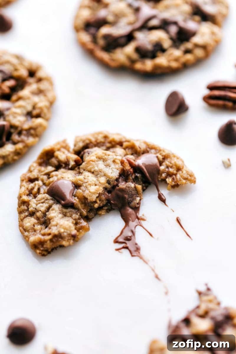 Oatmeal Chocolate Chip Pecan Cookies - Gooey Chocolate Center Revealed Oatmeal chocolate chip pecan cookies split in half to reveal the gooey chocolate center.