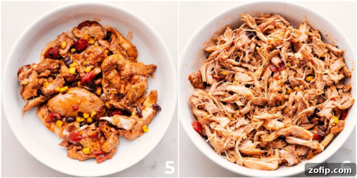 Close-up of shredded chicken being returned to the crockpot, ready to be stirred into the creamy chili.