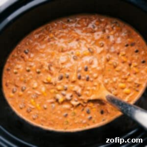 A bowl of creamy slow cooker chicken chili with toppings