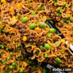 Pork and Ramen Noodle Stir Fry 2 Pork Ramen Stir Fry being picked up with tongs ready to be served and enjoyed, highlighting the delicious texture of the noodles and pork.