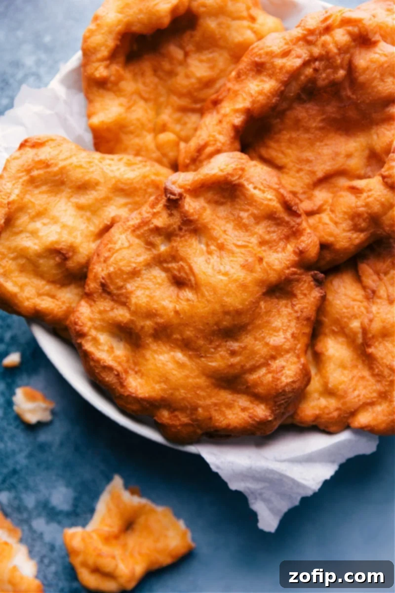 Overhead image of the golden-brown Fry Bread pieces arranged on a plate, garnished with powdered sugar, ready to be served