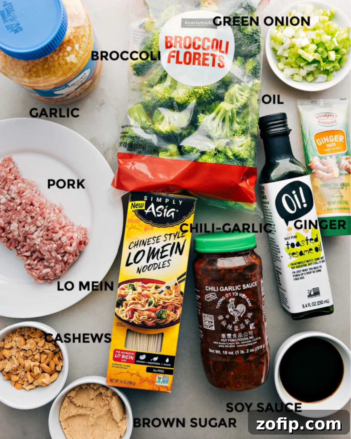 Ingredients In Dragon Noodles All the fresh ingredients for Dragon Noodles, including ground pork, vibrant green broccoli, crisp green onions, various noodles, chili garlic sauce, fresh ginger, rich soy sauce, brown sugar, and whole cashews, neatly prepped and laid out for easy assembly.