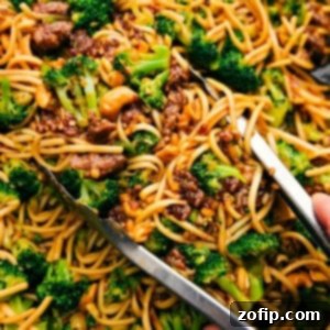 Fiery Dragon Noodles 3 Dragon Noodles with tongs picking some up.