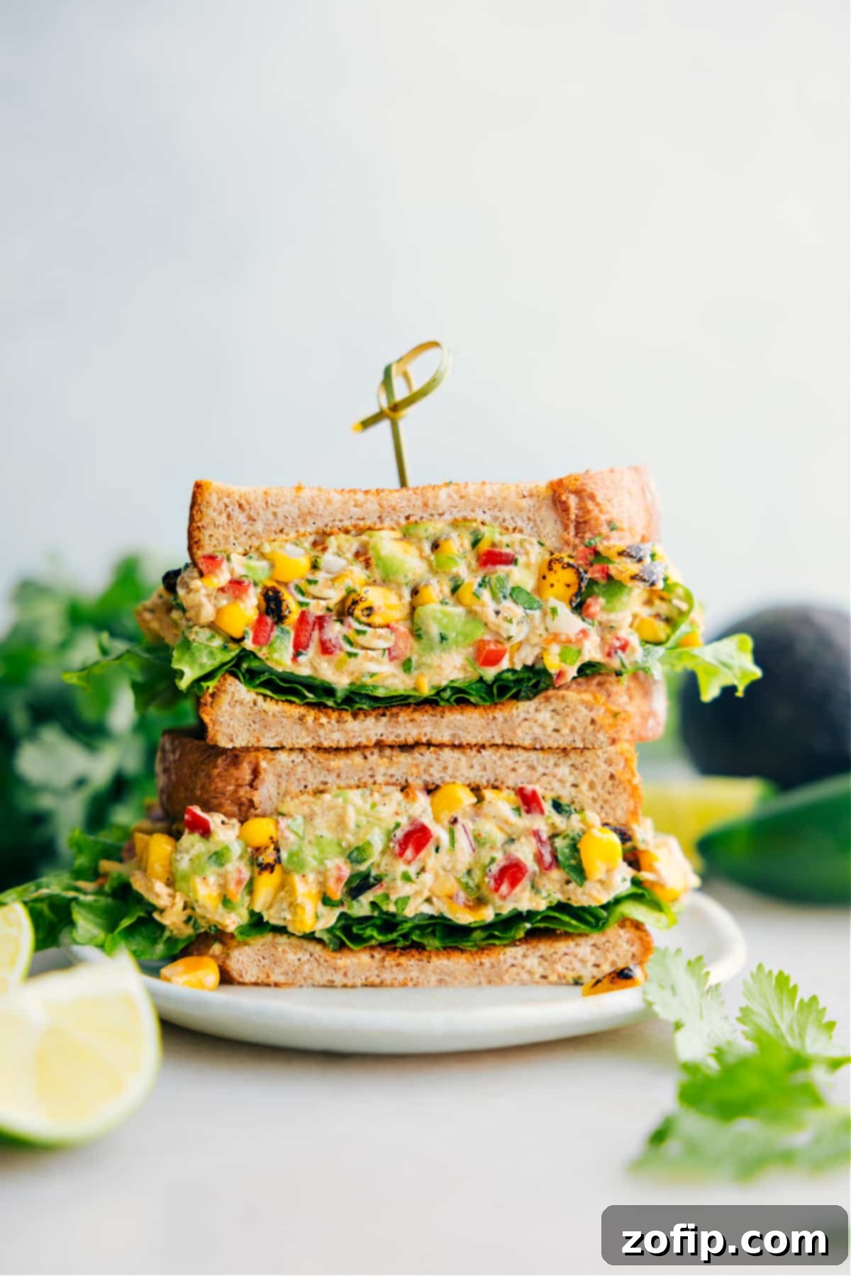 Elote Chicken Salad 2 Mexican Street Corn Chicken Salad served in a sandwich with fresh lettuce leaves.