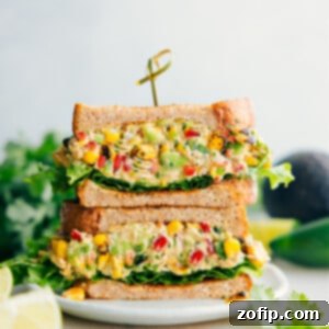 Elote Chicken Salad 5 Mexican Street Corn Chicken Salad sandwiched between bread and lettuce, showcasing the vibrant ingredients.