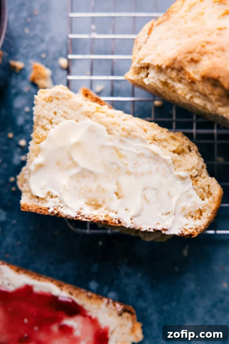 This simple No Yeast Bread can be prepared in a matter of minutes and doesn't require any rising time! Bake it up and enjoy a delicious slice of hot baked bread in under 90 minutes! Recipe via ChelseasMessyApron #snack #quick #easy #simple #best #fresh #norise #noyeast #bread Overhead shot of a beautifully golden brown loaf of No-Yeast Bread, freshly baked and ready to be sliced, highlighting its crisp crust.