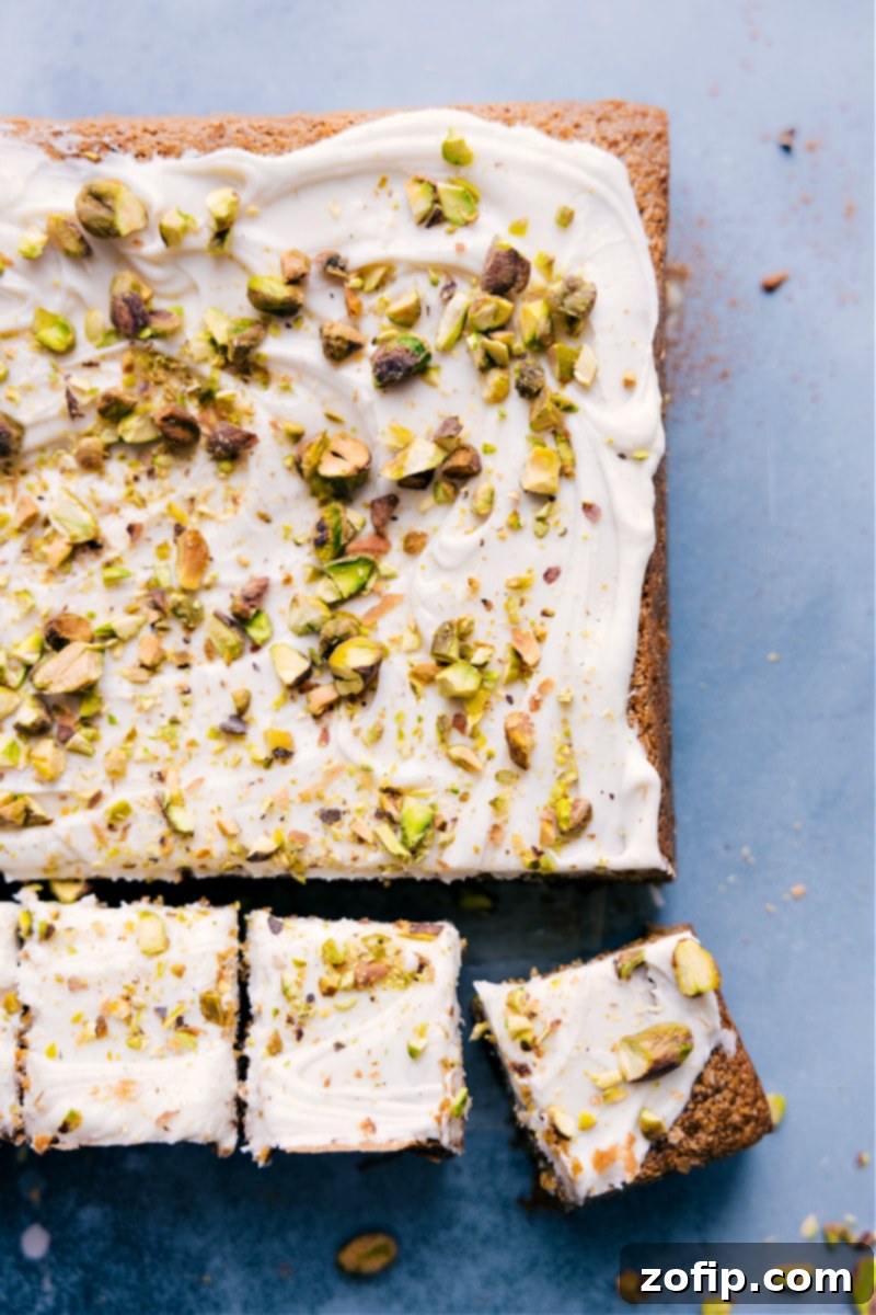 Overhead shot of the entire Pistachio Cake, perfectly frosted and garnished with chopped pistachios, ready to be served and enjoyed by a family.