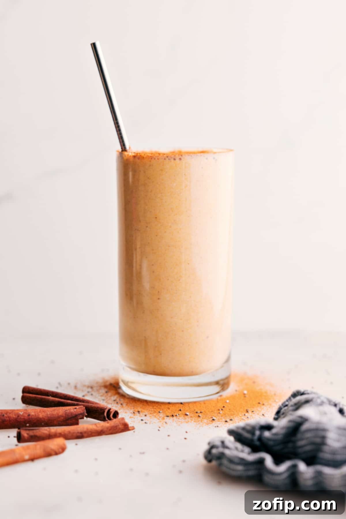 Golden Milk Smoothie: The Best Cold Turmeric Drink A vibrant golden milk smoothie in a glass with a straw, garnished with a sprinkle of cinnamon.