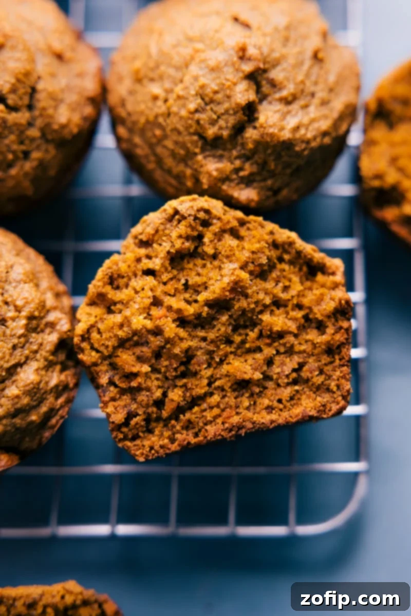 Delicious Healthy Carrot Muffins: Gluten-Free, Dairy-Free, Refined Sugar-Free, and Vegan. Perfect for a wholesome snack or breakfast. Overhead image of freshly baked Healthy Carrot Muffins on a wooden board, showcasing their golden-brown tops and moist interior. They are a perfect wholesome snack.
