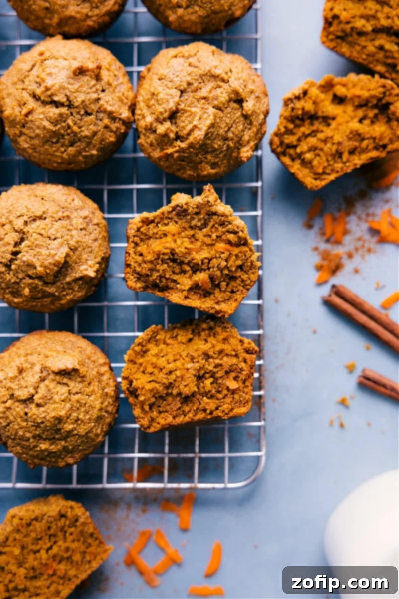 Guilt-Free Carrot Muffins 3 A vibrant stack of freshly baked healthy carrot muffins on a cooling rack, golden brown and ready to be savored as a wholesome, homemade treat.