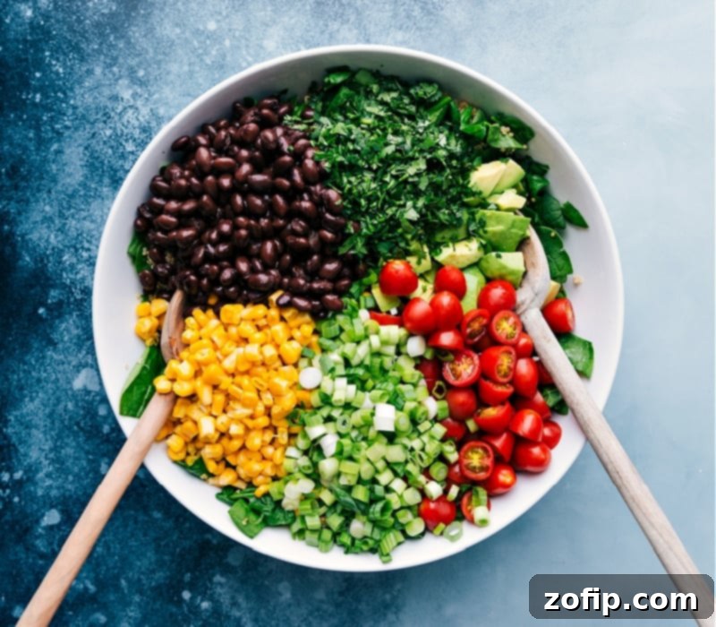 A vibrant close-up of the finished Quinoa Vegetable Salad, showing the colorful mix of ingredients like black beans, corn, tomatoes, green onions, and fresh cilantro, perfectly dressed and ready to eat.