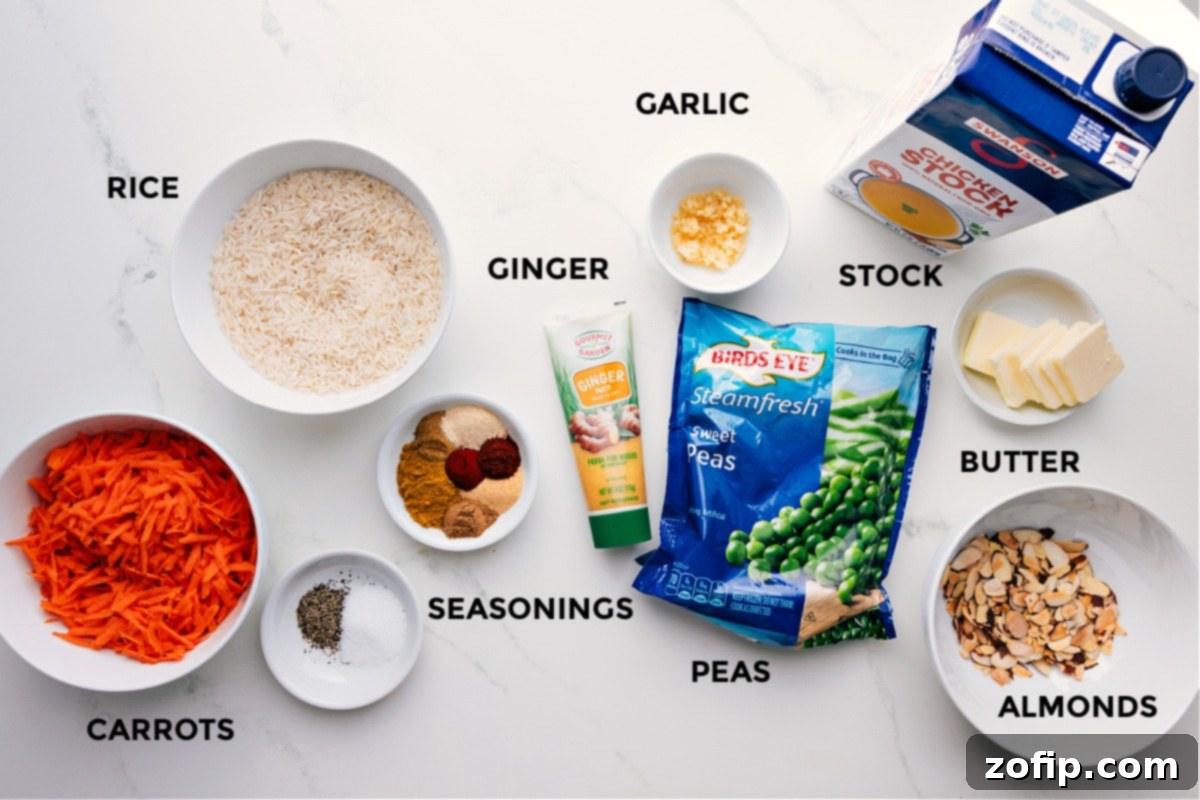Key Ingredients for One-Pan Curry Rice All the vibrant ingredients for curry rice meticulously prepped and laid out for easy assembly, including basmati rice, chicken stock, various spices, fresh grated carrots, minced garlic, ginger paste, frozen peas, butter, and sliced almonds.
