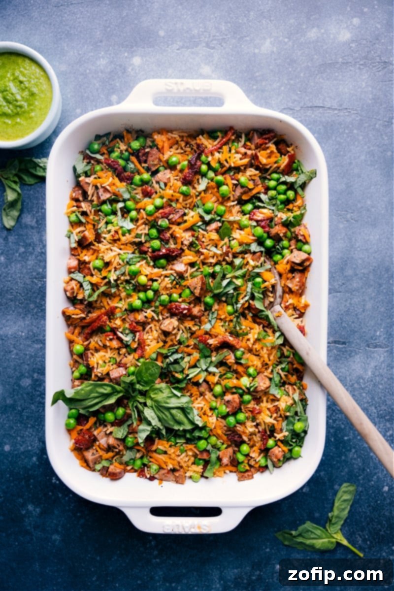Overhead view of Pesto Rice, a complete meal in one pan with smoked chicken sausage, vegetables, and basil pesto.
