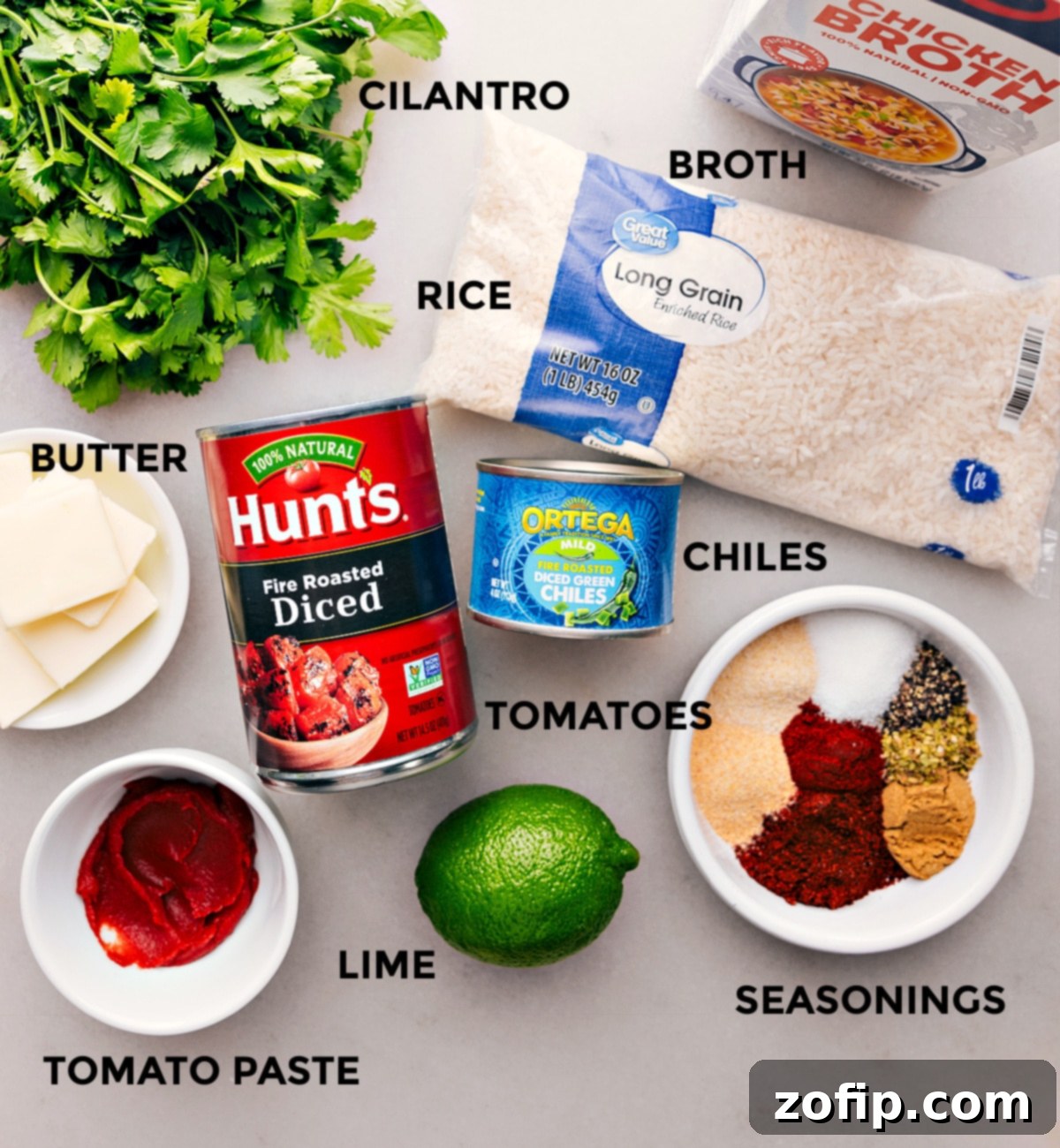 All the fresh ingredients for the Mexican Rice Recipe prepped and laid out for easy assembly, including long-grain rice, diced tomatoes, green chiles, and a blend of aromatic spices.