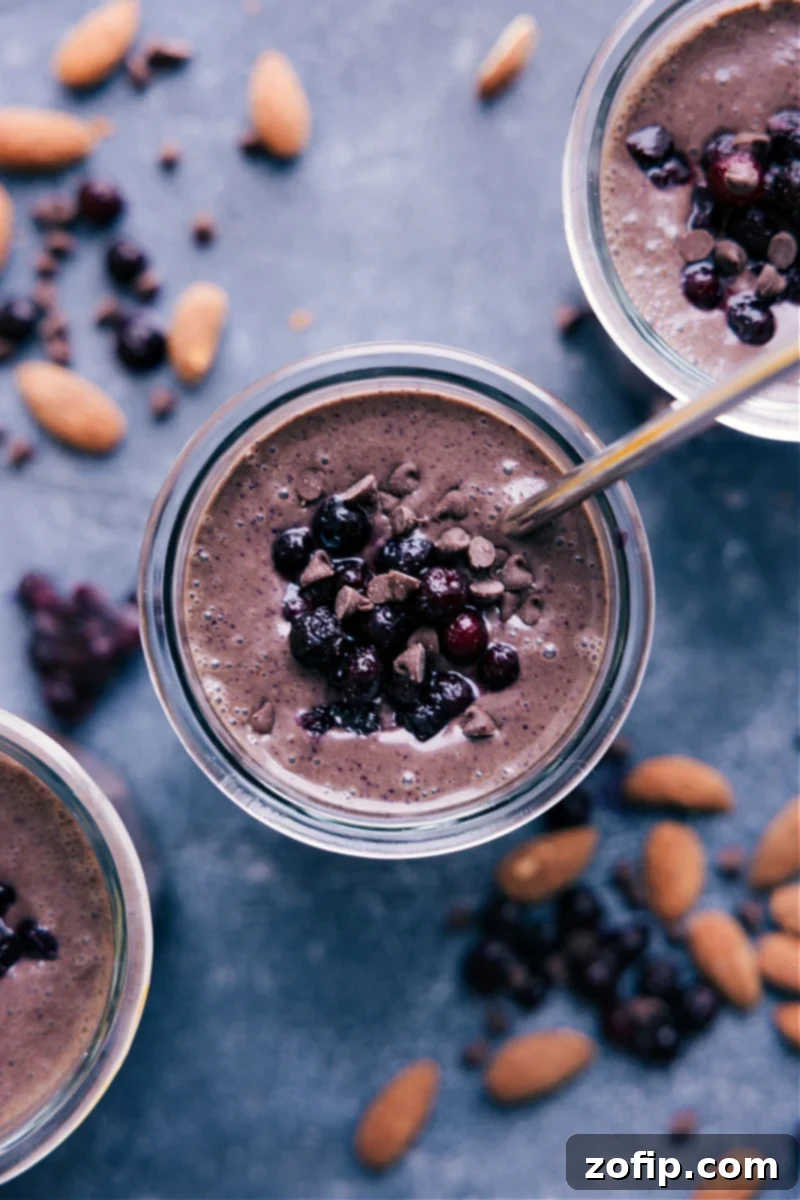 Overhead view of a perfectly blended Chocolate Blueberry Smoothie in a glass, garnished with fresh blueberries.