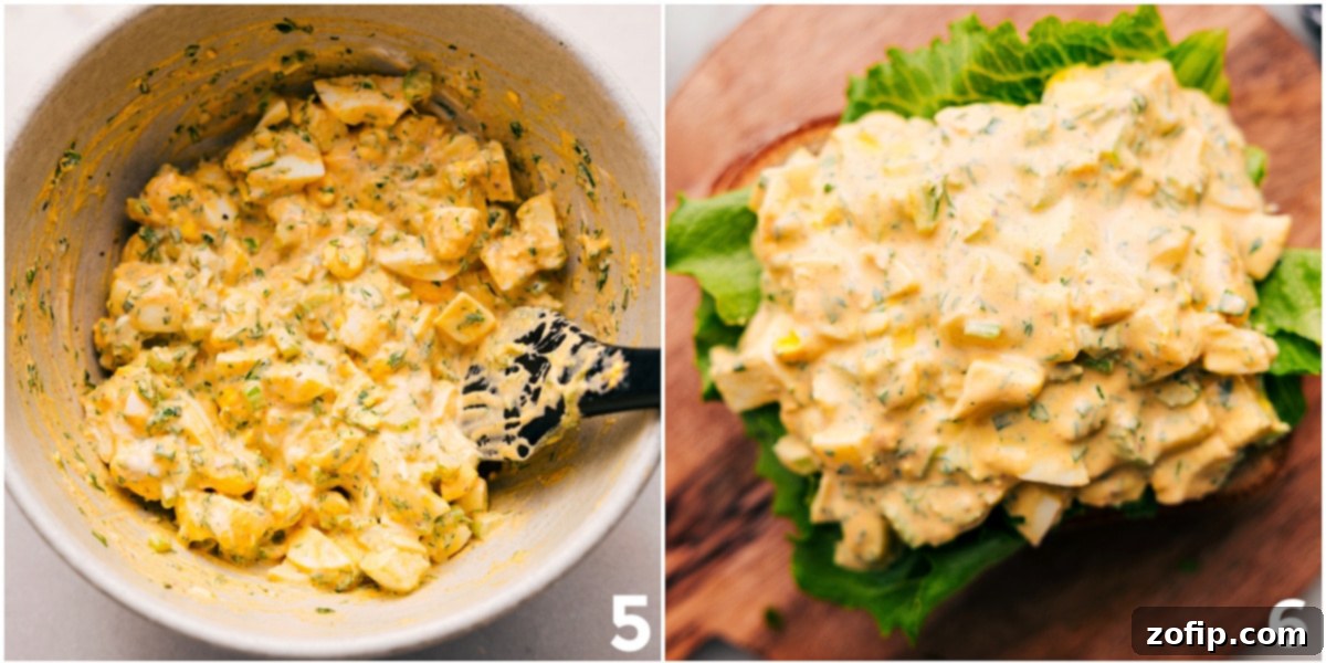 The finished egg salad mixture being generously topped onto fresh bread, ready to be assembled into a delicious sandwich.