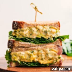 Close-up of a perfectly prepared egg salad sandwich, showcasing its creamy texture and fresh ingredients.