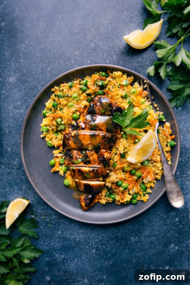 Overhead image of Moroccan Chicken with couscous and apricot sauce, garnished with parsley