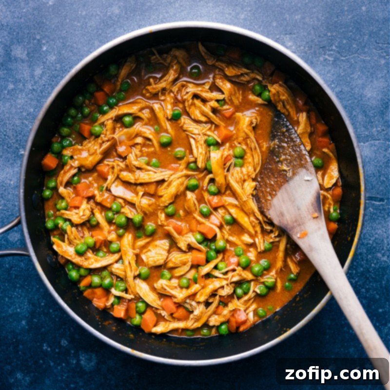 Garam Masala Chicken simmering in a non-stick pan, showing its rich sauce and vibrant vegetables.