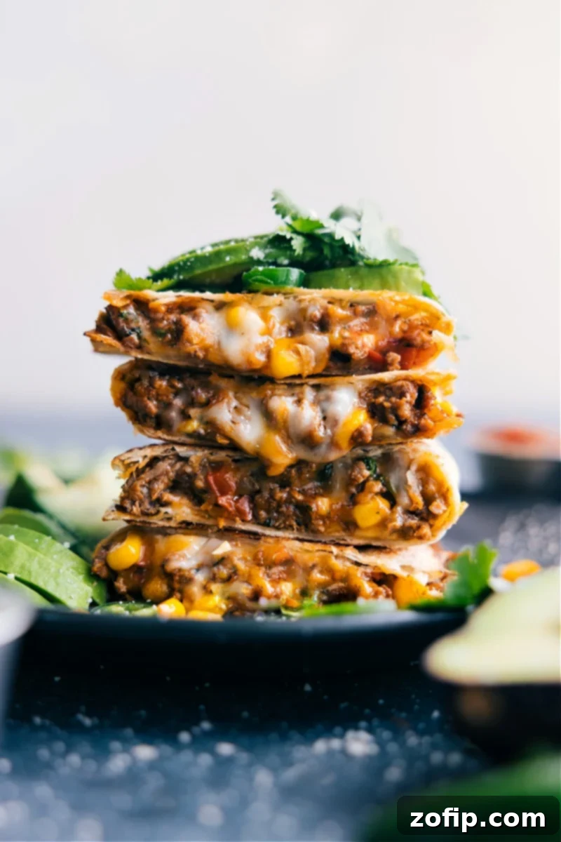 A vibrant close-up of perfectly cooked Ground Beef Quesadillas, stacked and ready to be served, highlighting their golden-brown tortillas and delicious, savory filling.