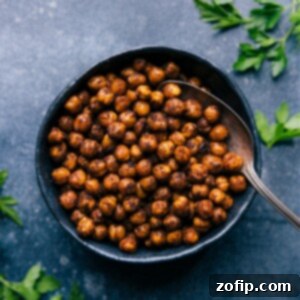 A close-up shot of crispy Air Fryer Chickpeas seasoned with savory spices, served in a small bowl.