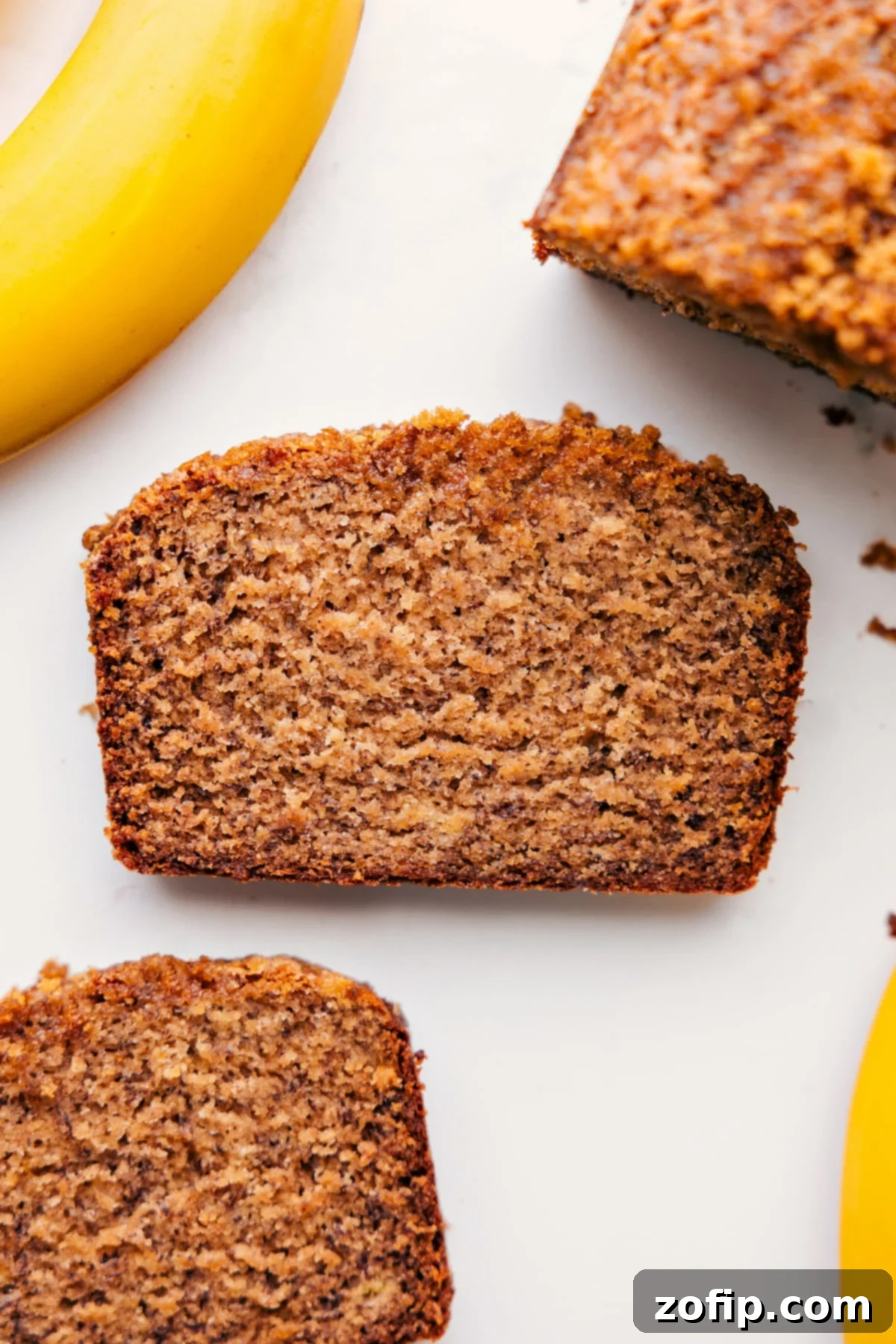 A perfectly sliced piece of Greek yogurt banana bread, showcasing its moist texture and golden crust, ready to be enjoyed for breakfast or dessert.