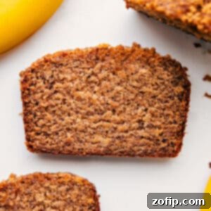A slice of moist Greek Yogurt Banana Bread, featuring its rich golden-brown crust and soft interior.