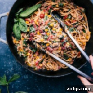 Finished Summer Pasta with Zucchini and Italian Sausage in a skillet, ready to be served.
