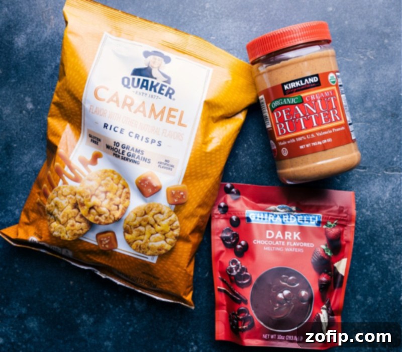 All the essential ingredients for making Rice Cake with Peanut Butter and Chocolate laid out on a clean surface. Visible items include a bag of caramel rice cakes, a jar of creamy peanut butter, chocolate melting wafers, and a small bottle of coconut oil, ready for easy assembly.