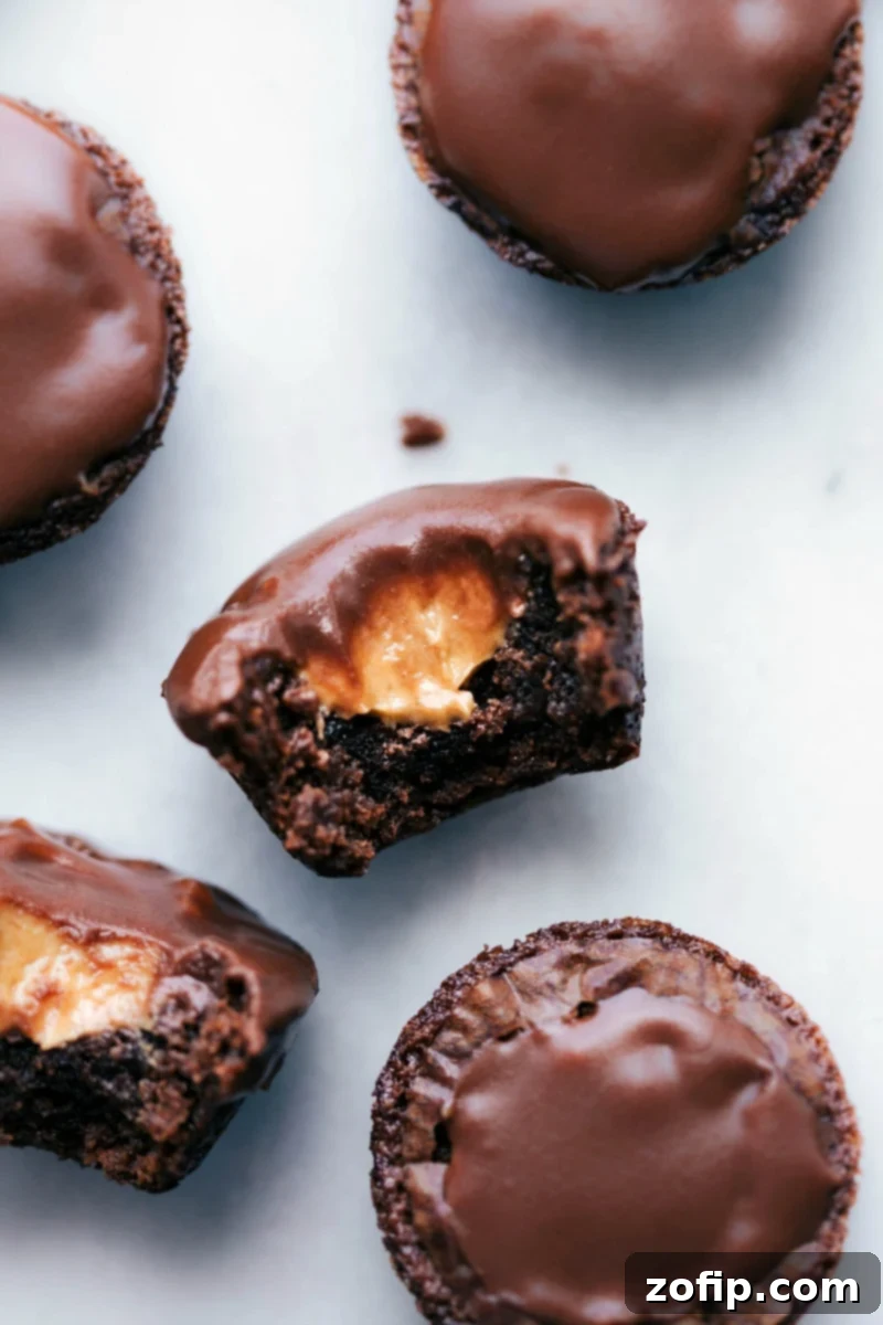 Irresistible Bitten Peanut Butter Brownie Bite with Melting Center A close-up image of a delectable peanut butter brownie bite with a corner bitten off, revealing the melting, creamy peanut butter center.