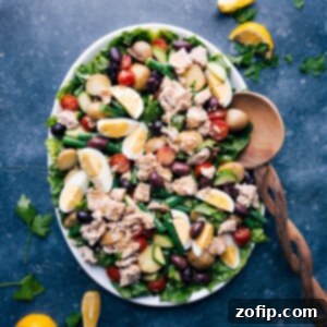 Vibrant Tuna Nicoise 8 A vibrant Tuna Niçoise Salad with all its components, artfully arranged on a white plate, highlighting the freshness and appeal of this classic dish.