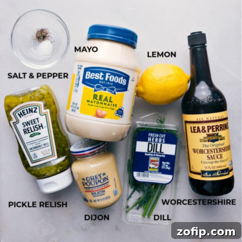A flat lay photograph showcasing all the fresh and vibrant ingredients laid out for making the homemade Tartar Sauce recipe.