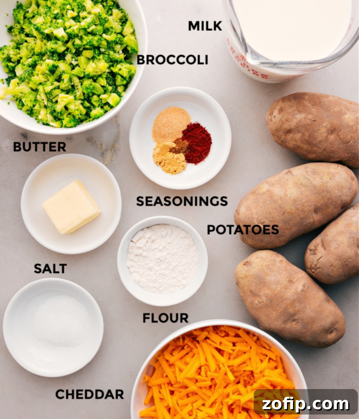 Essential Ingredients for Crafting Delicious Broccoli And Cheese Baked Potatoes A vibrant selection of ingredients laid out on a kitchen counter: fresh broccoli florets, blocks of sharp cheddar cheese, whole milk, butter, flour, and a variety of aromatic spices, all ready for making the broccoli and cheese sauce.