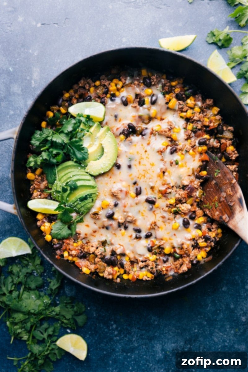Up-close overhead image of the Green Chile Ground Turkey, showcasing the melted cheese, black beans, corn, and fresh cilantro garnish.