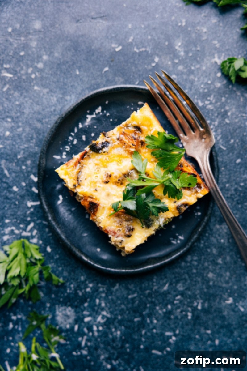 Overhead image of a single slice of the Vegetable Frittata, showing the layers of eggs, vegetables, and melted cheese inside.