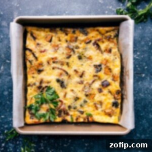 A freshly baked slice of vegetable frittata on a plate.