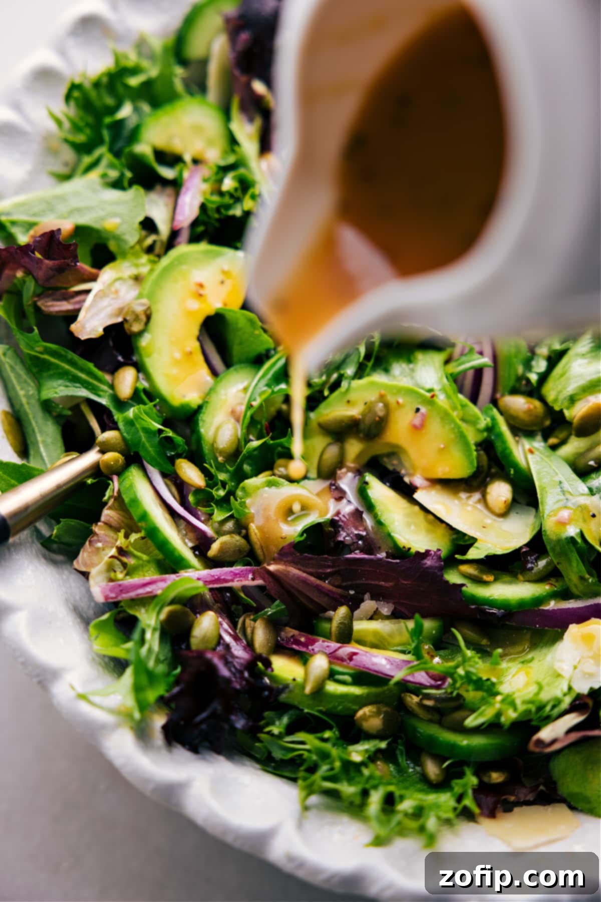 Drizzling dressing over this favorite everyday salad.