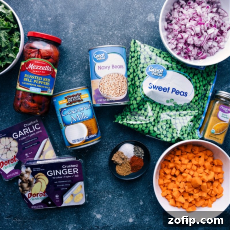 Quick Vegan Curry ingredients shot. Recipe via ChelseasMessyApron #dinner #easy #simple #best #fresh #cleaneating #vegetarian #familyfriendly #kidfriendly #quick #vegan #curry A vibrant flat lay image showcasing all fresh ingredients used to make the quick vegan curry, including various vegetables, spices, coconut milk, and beans.