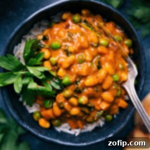 Vibrant Vegan Curry 2 A serving of the delicious vegan curry in a bowl, garnished with fresh herbs, showcasing its rich texture and vibrant color, ready to be eaten.