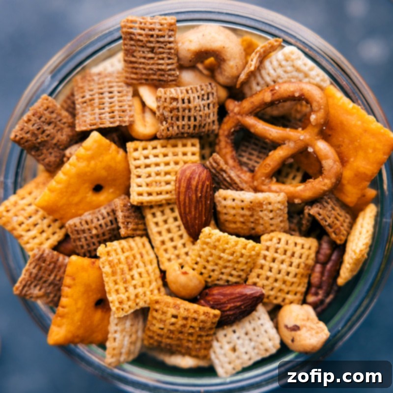 Close-up overhead view of the finished Chex Mix, highlighting the crispy texture and even coating of seasoning on all components.