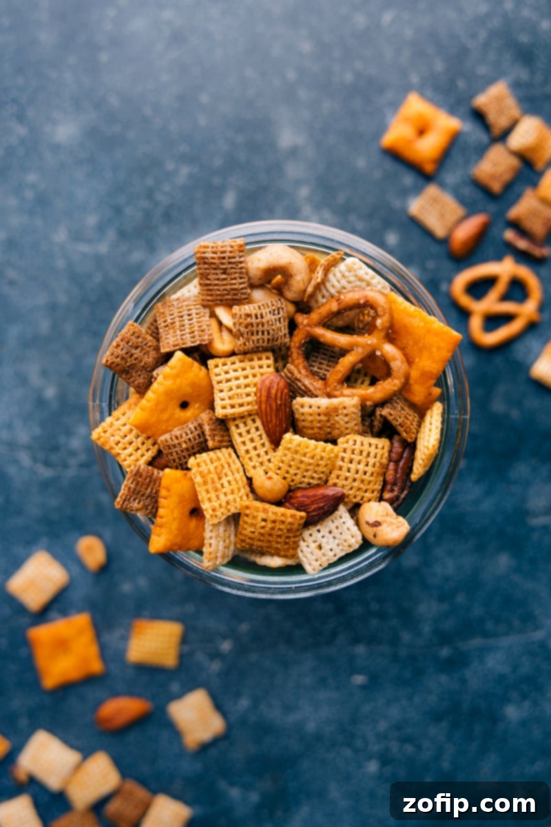 Overhead view of a large serving bowl filled with a fresh batch of golden, crispy Chex Mix, ready to be enjoyed.