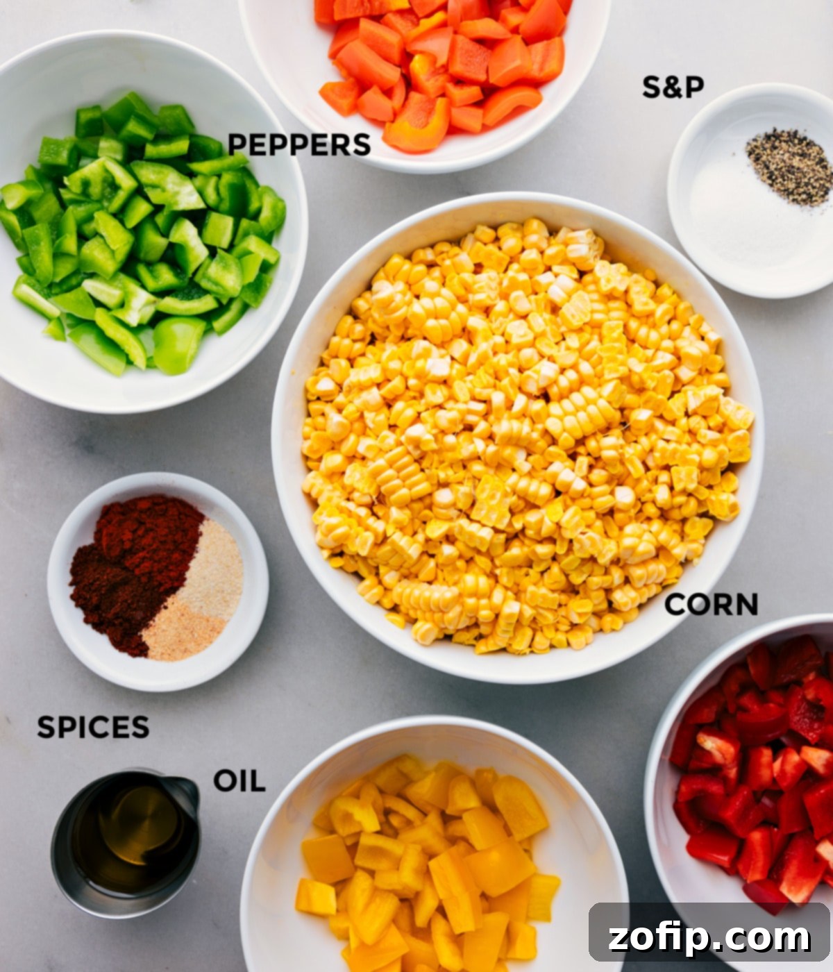All the ingredients for roasted corn, including fresh corn kernels, various colored bell peppers, olive oil, and a selection of spices, prepped and ready for mixing.