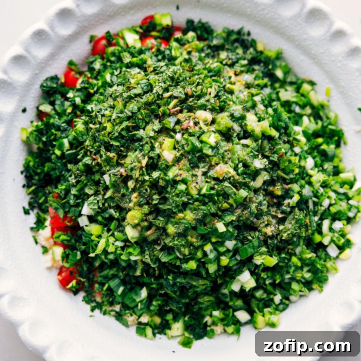 All the ingredients for Tabouli are combined in a large bowl, ready to be mixed and dressed for a delicious, fresh salad.